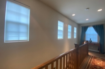 Motorized roller shades high up windows above stairs in denver