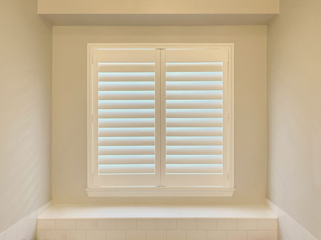 Hunter Douglas Palm Beach Polysatin Shutters with Front Center Tilt and Z Frame installation in Boulder bathroom