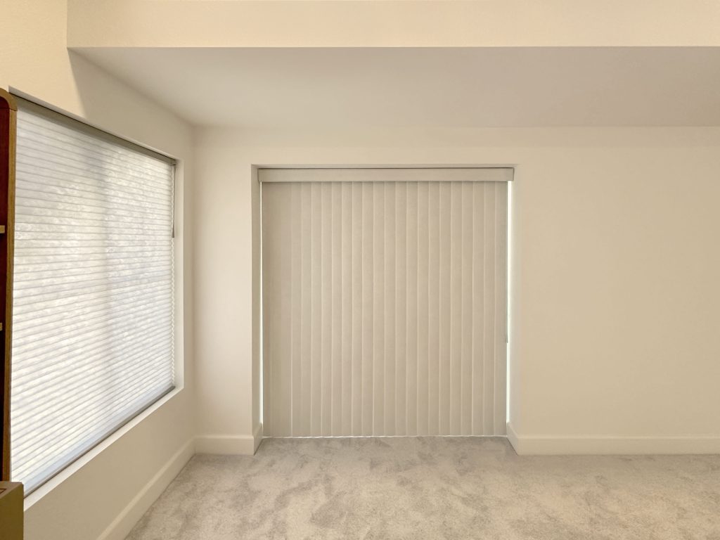 Hunter Douglas Applause Cellular Shades and Vertical Solutions Vertical Blinds with UltraGlide and wand control, left stack configuration, and light filtering fabric installed in Denver Home