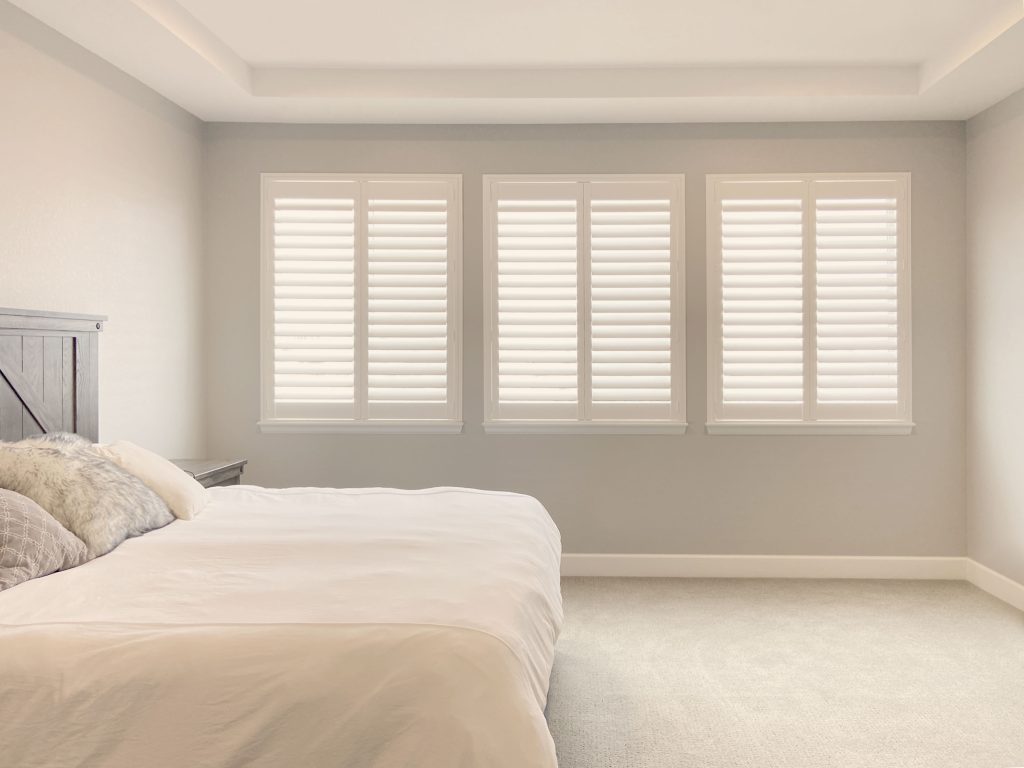 Hunter Douglas Palm Beach Polysatin Shutters in Denver bedroom with hidden tilt system and Z frame design