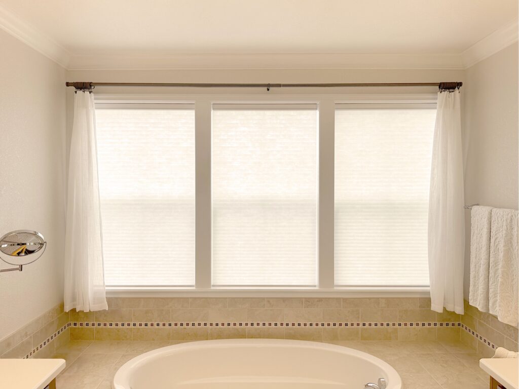 Hunter Douglas Applause Cellular Shades paired with curtains/sheers for Colorado bathroom