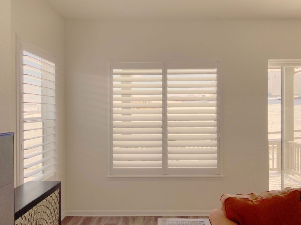 Hunter Douglas Palm Beach Polysatin Shutters with hidden tilt control and Z Frame for living room in Littleton home
