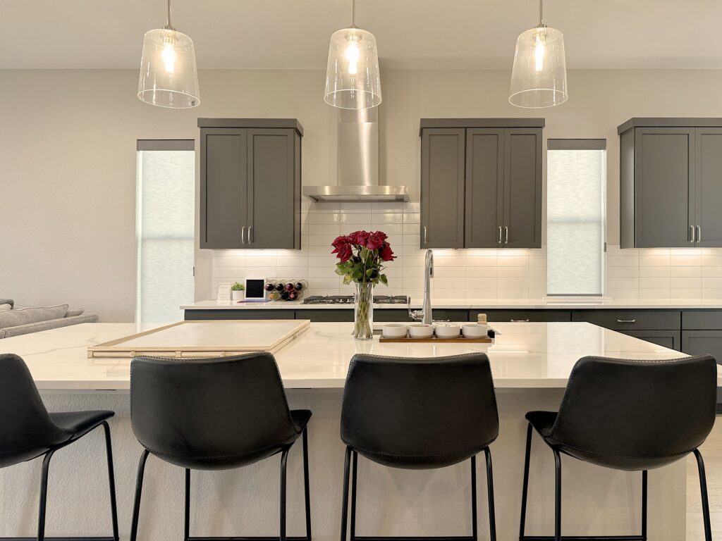 Elegant Aurora Designer Roller Shades with Custom Clutch and Light Filtering in a modern kitchen setting.