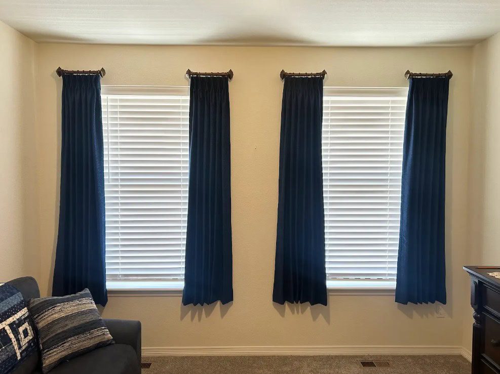 Carole Fabrics side panels paired with Hunter Douglas Parkland Natural Wood Blinds in Aurora home, featuring the SimpleLift cordless operation for a modern and safe window treatment.
