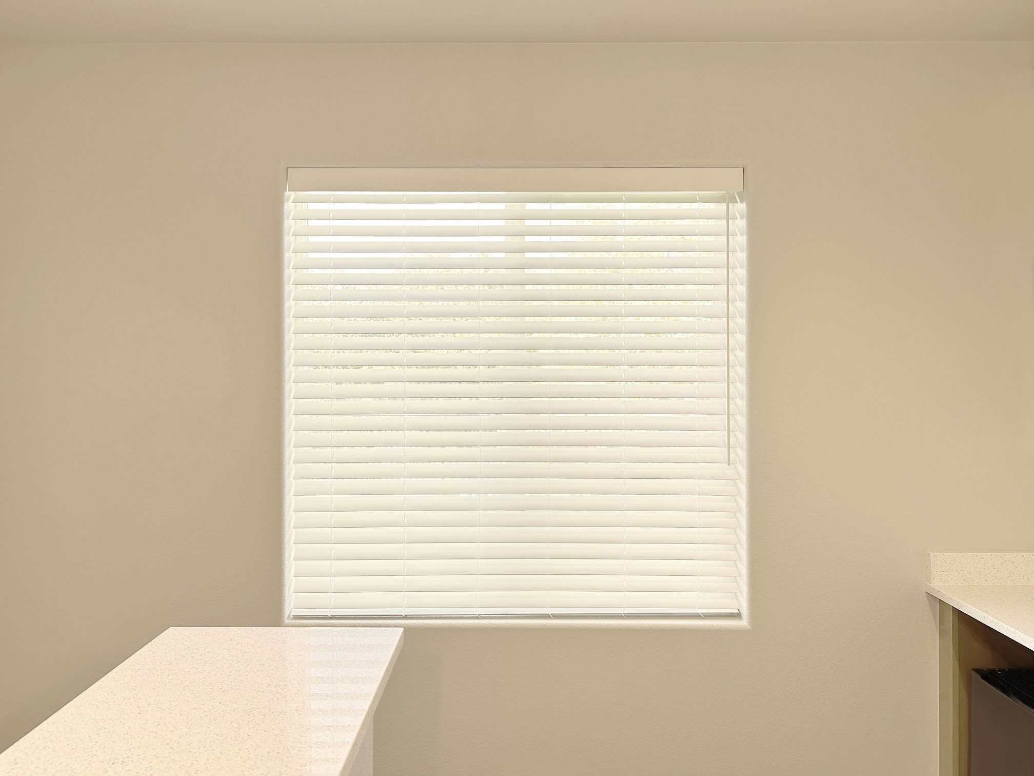 Window with white blinds in a Denver home interior.
