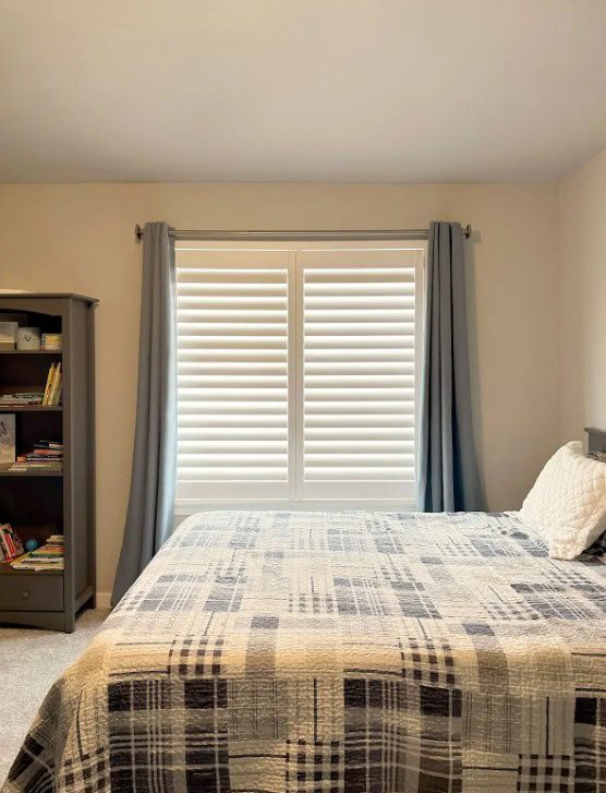 Hunter Douglas Palm Beach Polysatin Shutters with Hidden Tilt and layered with curtains in Aurora home.