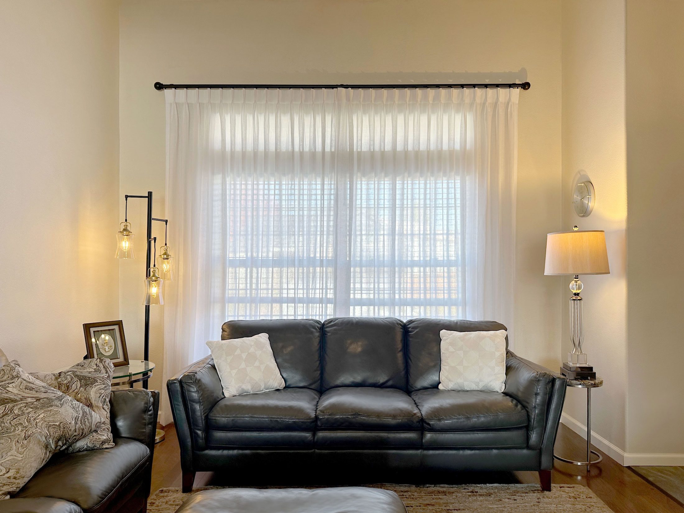 Custom white light-filtering Carole Fabrics curtains for living room windows