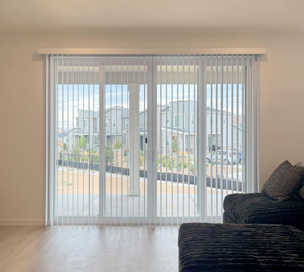 Vertical blinds for large glass patio door in Lone Tree home